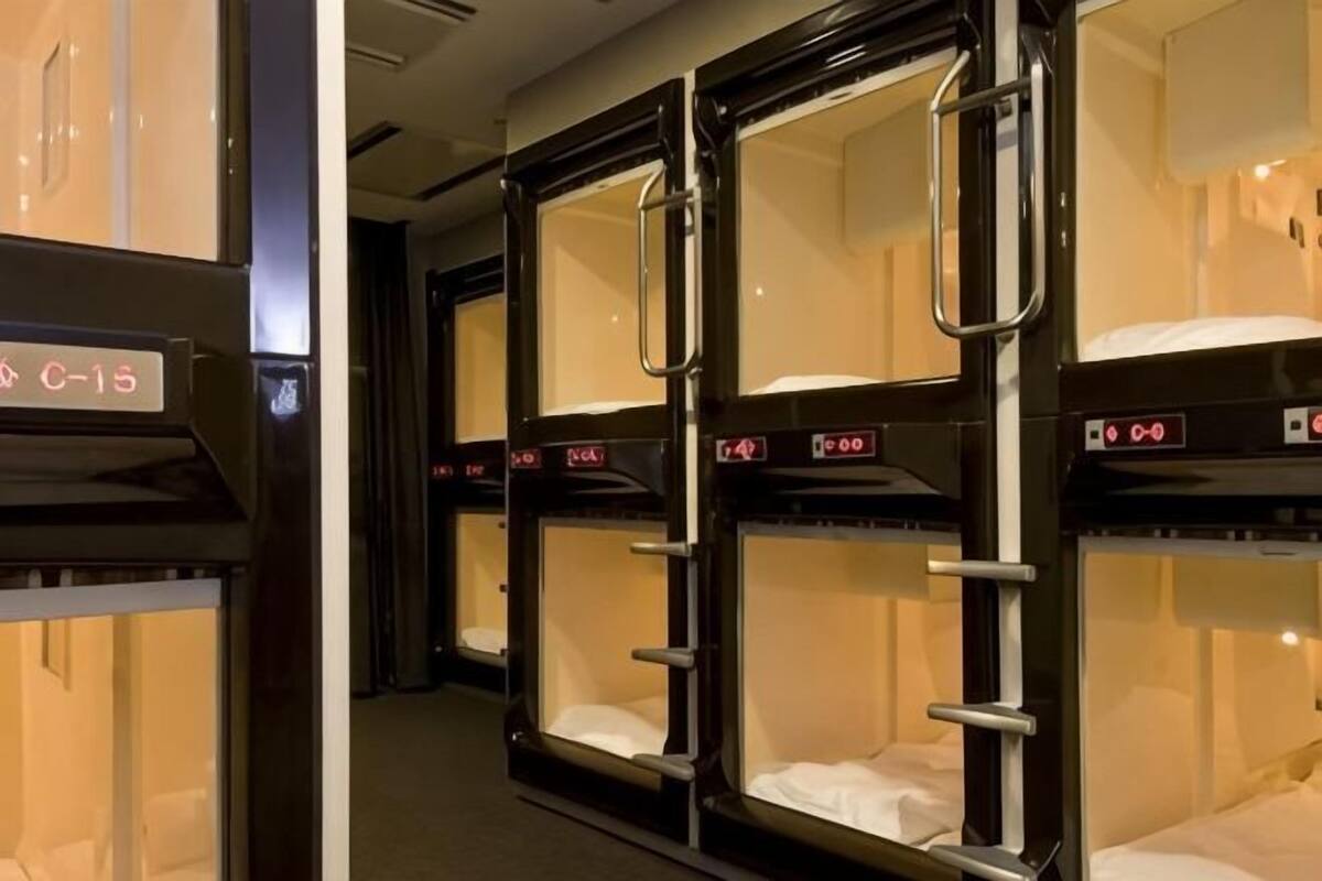 A row of bunk beds with metal railings and a digital display showing room number C-15.