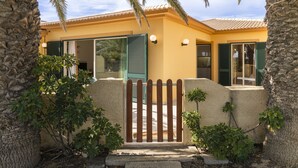 A house with a stone facade, green shutters, and a wooden gate. - Holidays in Porto Santo - Casa do Ribeiro Salgado (Porto Santo)