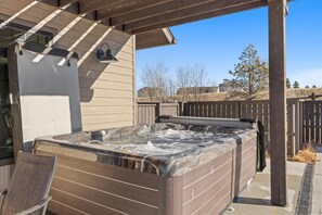 A hot tub under a wooden pergola with a chair nearby. - New! 5 BR w/ Rooftop Hot tub (Red Lodge)