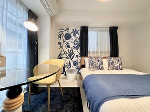 A hotel room with a bed, a chair, a table, and a large window. - RDBBF32_201 / Chuo-ku Tokyo (Chuo-ku)