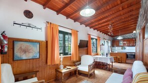 A wooden interior with a dining area, kitchen, and a large map on the wall. - Holiday Home 'Casa Rural Ondina A' with Sea View, Private Terrace and Wi-Fi (Hermigua)