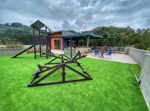 Relax in the playground and enjoy the scenic views of the surrounding forest from the covered seating area.