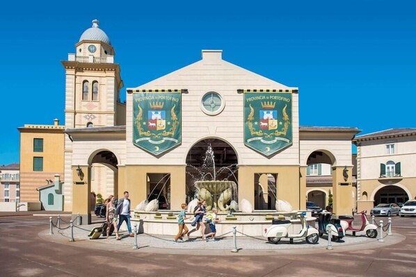 A building with two banners reading "Provincia di Portofino" and a fountain in front.