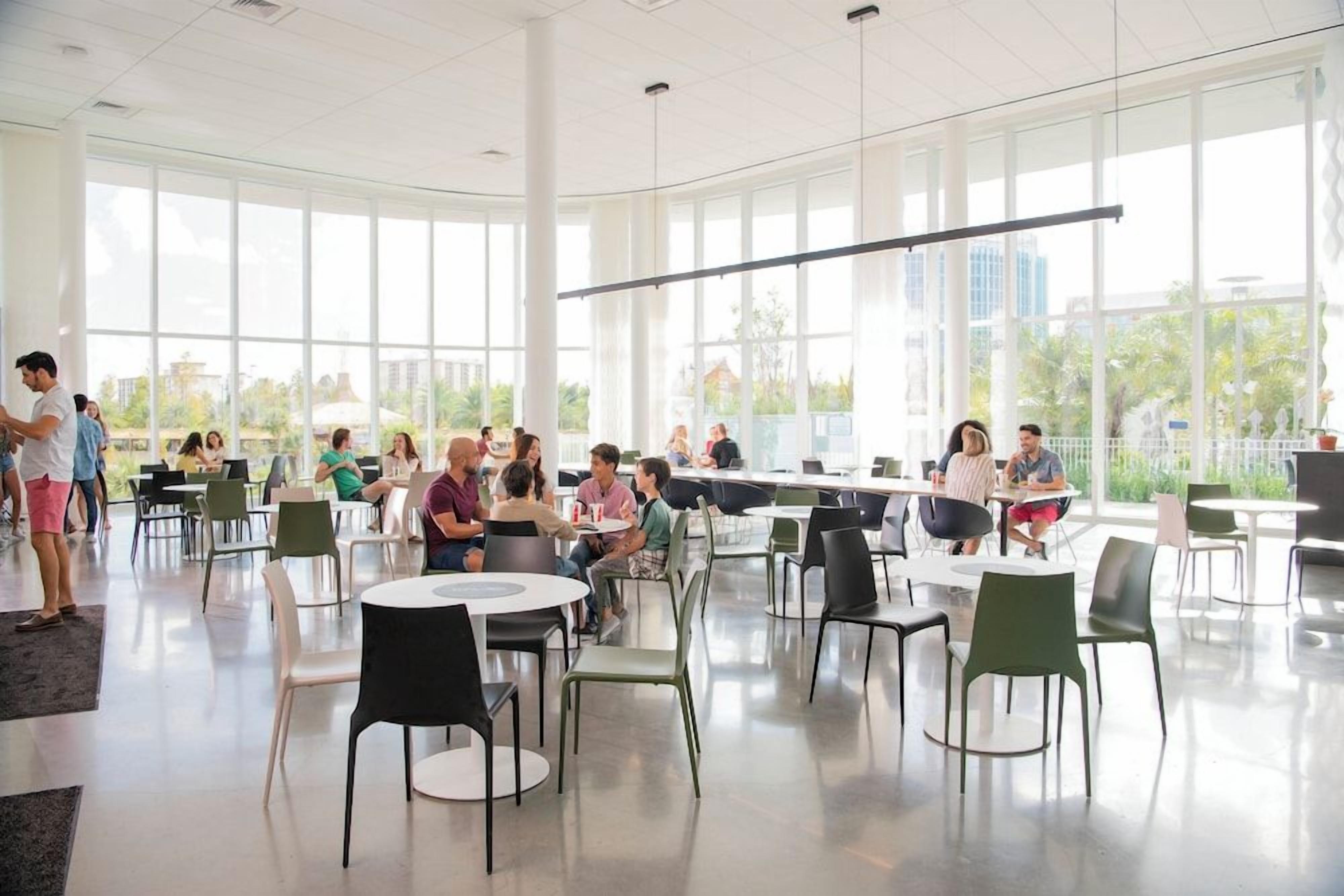 A spacious indoor area with tables and chairs arranged for group gatherings.