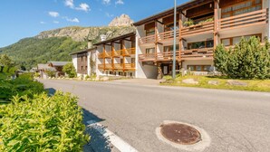 A building with multiple balconies, a mountain in the background, and a clear sky. - Studio de Balme w/Shared Pool & Near Slopes, Le Tour (Argentière), France (Le Tour (Argentière))