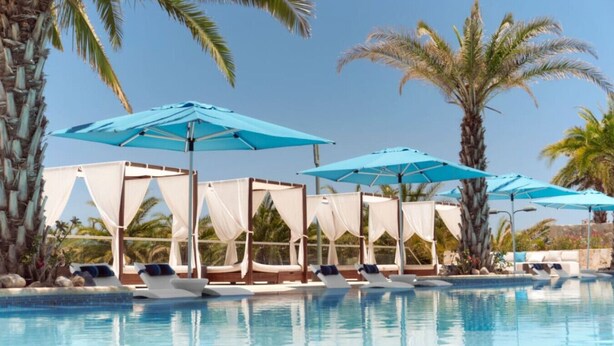 A pool area with multiple lounge chairs and canopies, surrounded by palm trees. - Beautiful Golf or Family Luxury Villas Dunes 1913 (Palmilla)