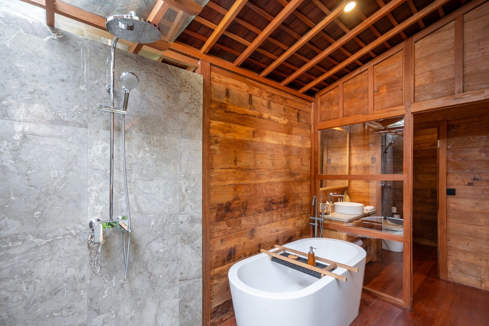 A bathroom with a shower, a sink, and a bathtub.