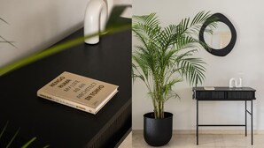 A modern bathroom with a black sink, a round mirror, and a potted plant. - Chic & Luminous 3BR Apartment in Kifisia (Kifisia)