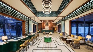 A spacious lobby with a central seating area, a reception desk, and large windows offering views of the outdoors. - Fortune Resort & Wellness Spa Bhaktapur, Nepal - Member ITC Hotels' Group (Suryabinayak)