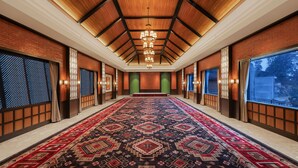 A spacious hotel lobby with a large patterned carpet, wooden ceiling beams, and large windows. - Fortune Resort & Wellness Spa Bhaktapur, Nepal - Member ITC Hotels' Group (Suryabinayak)