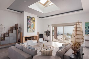Deluxe Villa | Living area | 60-inch Smart TV with cable channels, fireplace, video-game console - Aphea Retreat Villa (Aegina)