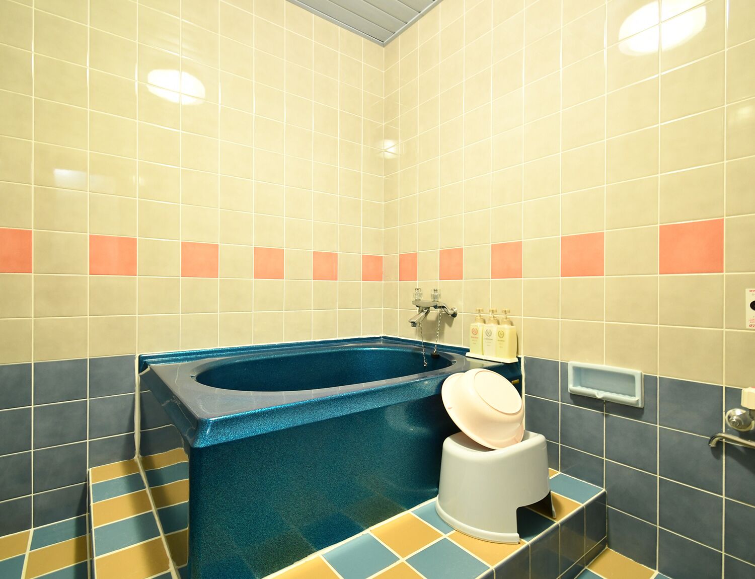 A bathroom with a bathtub, a toilet, and a sink.