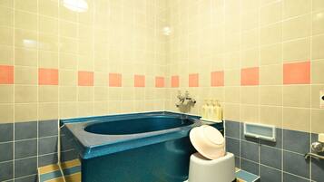 A bathroom with a bathtub, a toilet, and a sink.