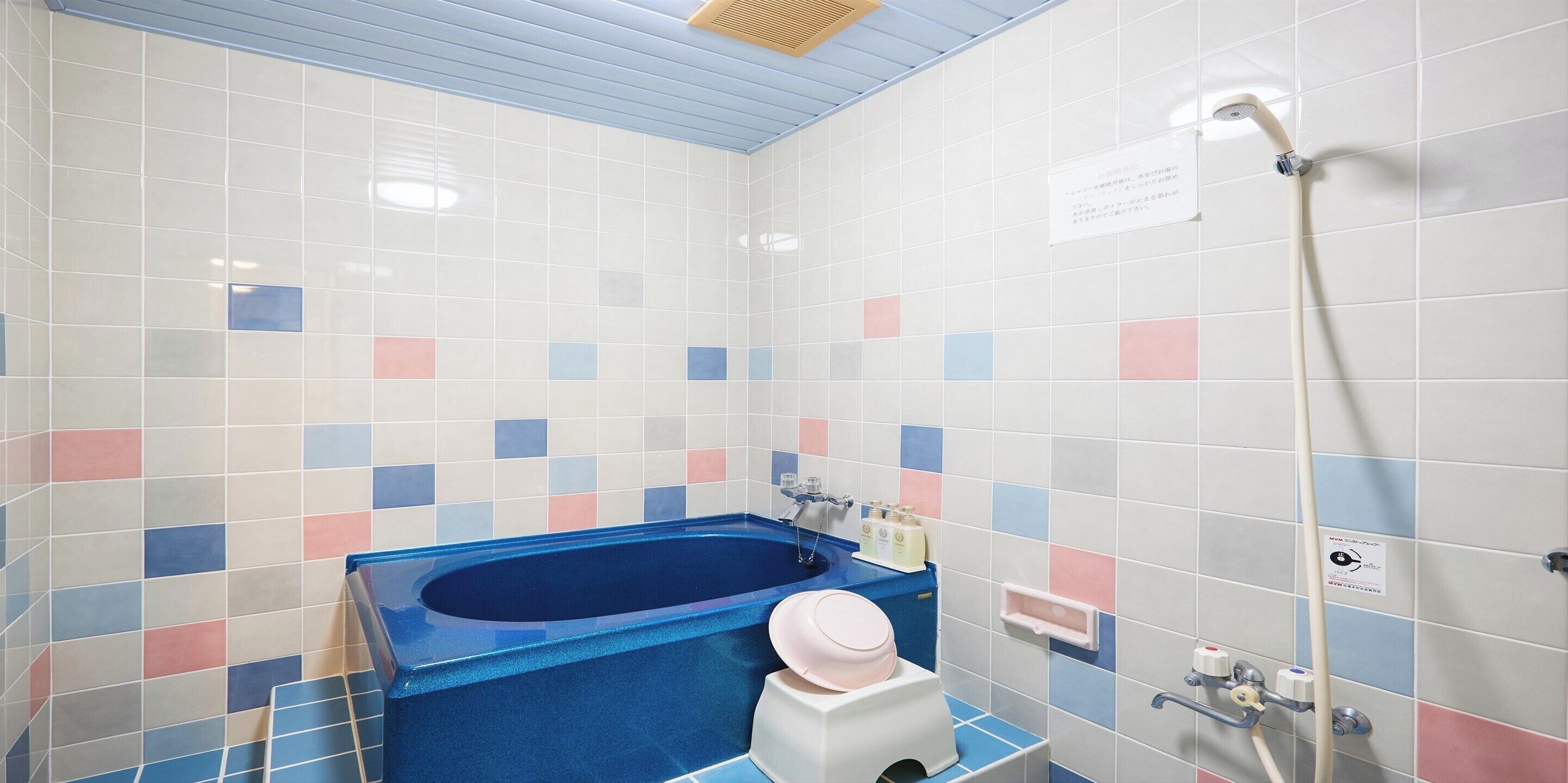 A bathroom with a bathtub, a toilet, and a shower.
