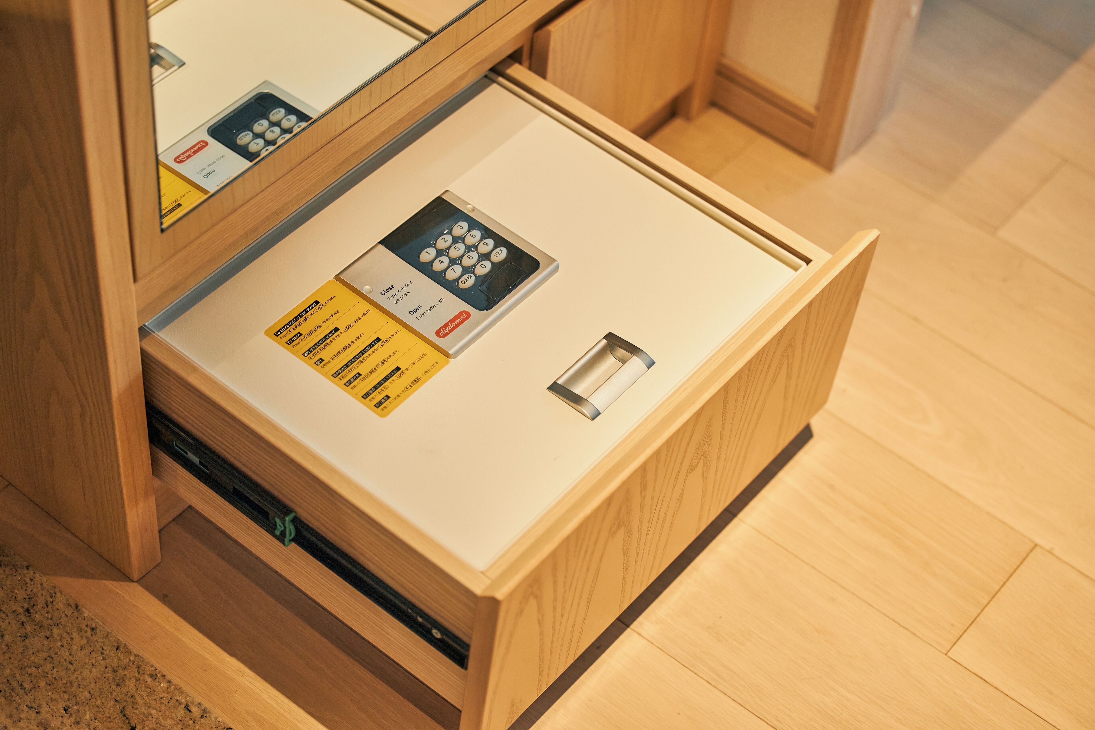 A wooden drawer with a built-in electronic lock and a card reader.