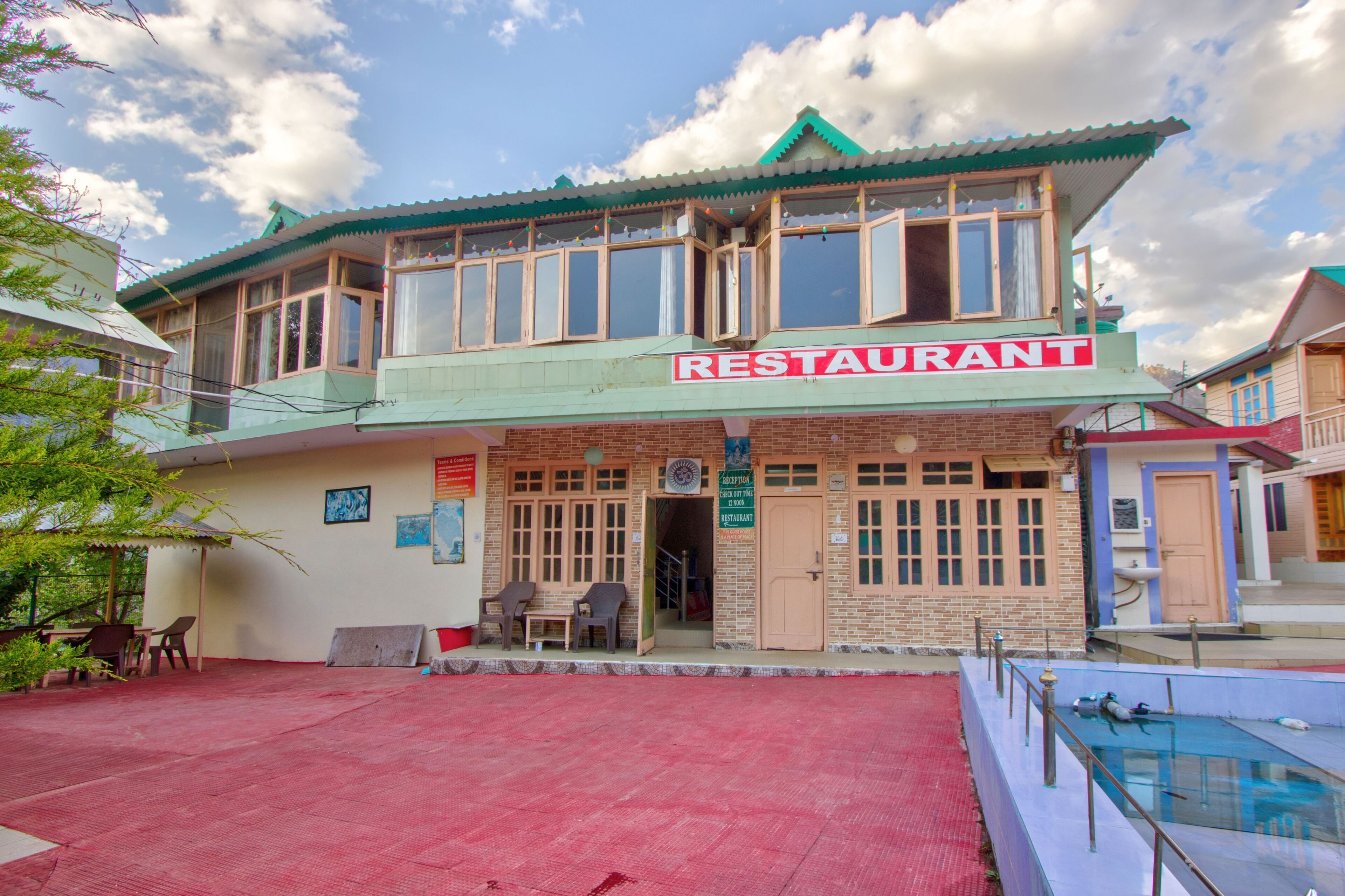 A two-story building with a sign reading "RESTAURANT" on the front.