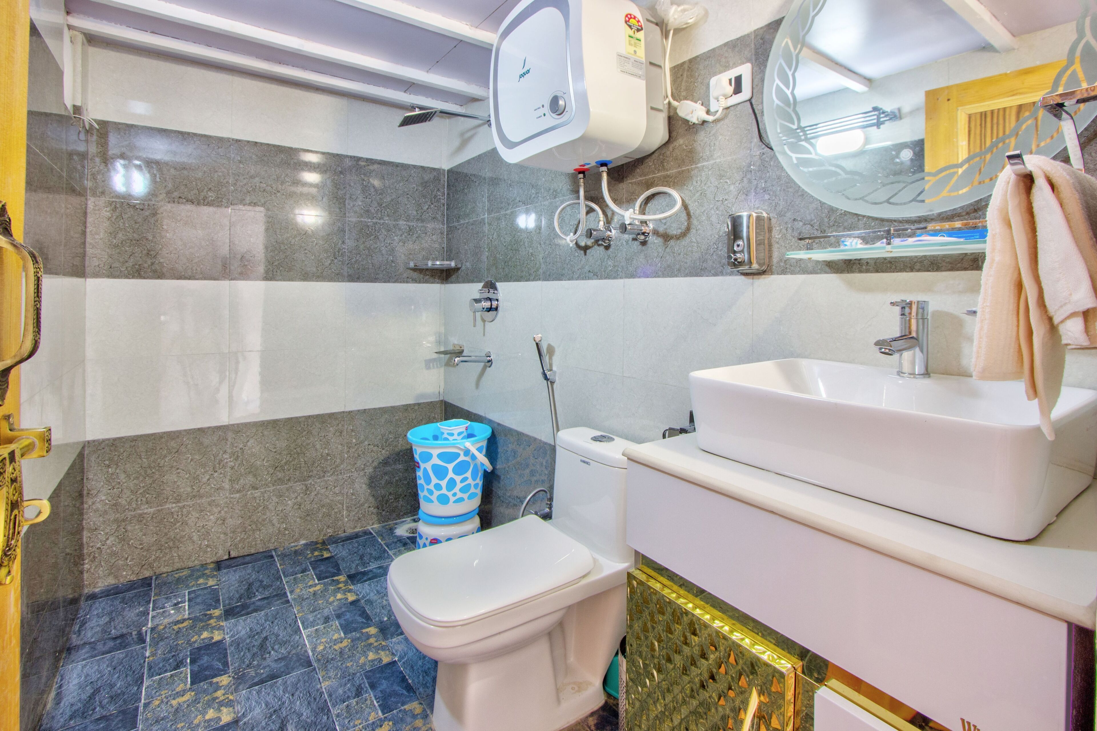 A bathroom with a toilet, sink, and shower.