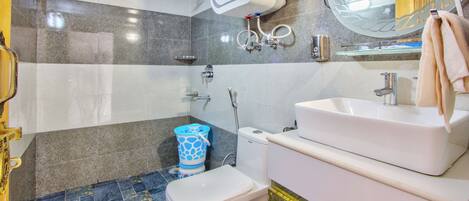 A bathroom with a toilet, sink, and shower.
