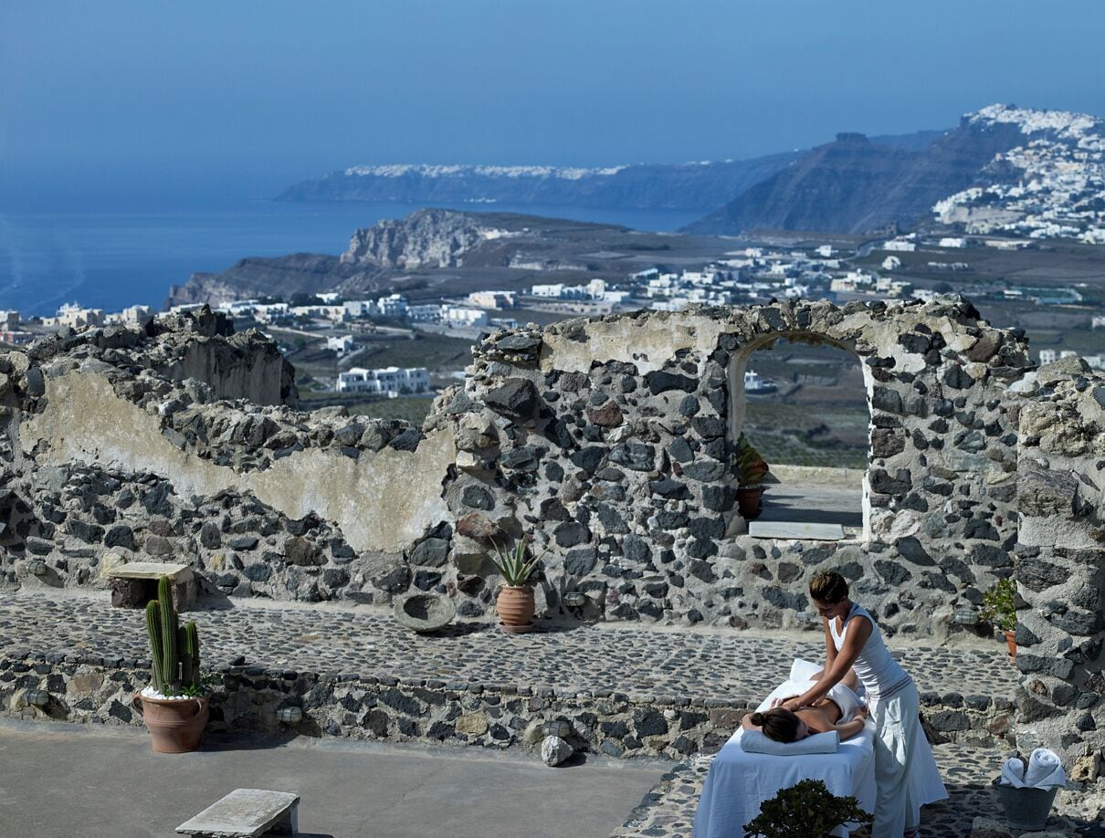 A stone structure with a person performing a massage.