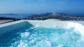 A hot tub with a clear view of a coastal landscape and distant mountains. - Zannos Melathron Hotel by Omilos Hotels (Santorini)