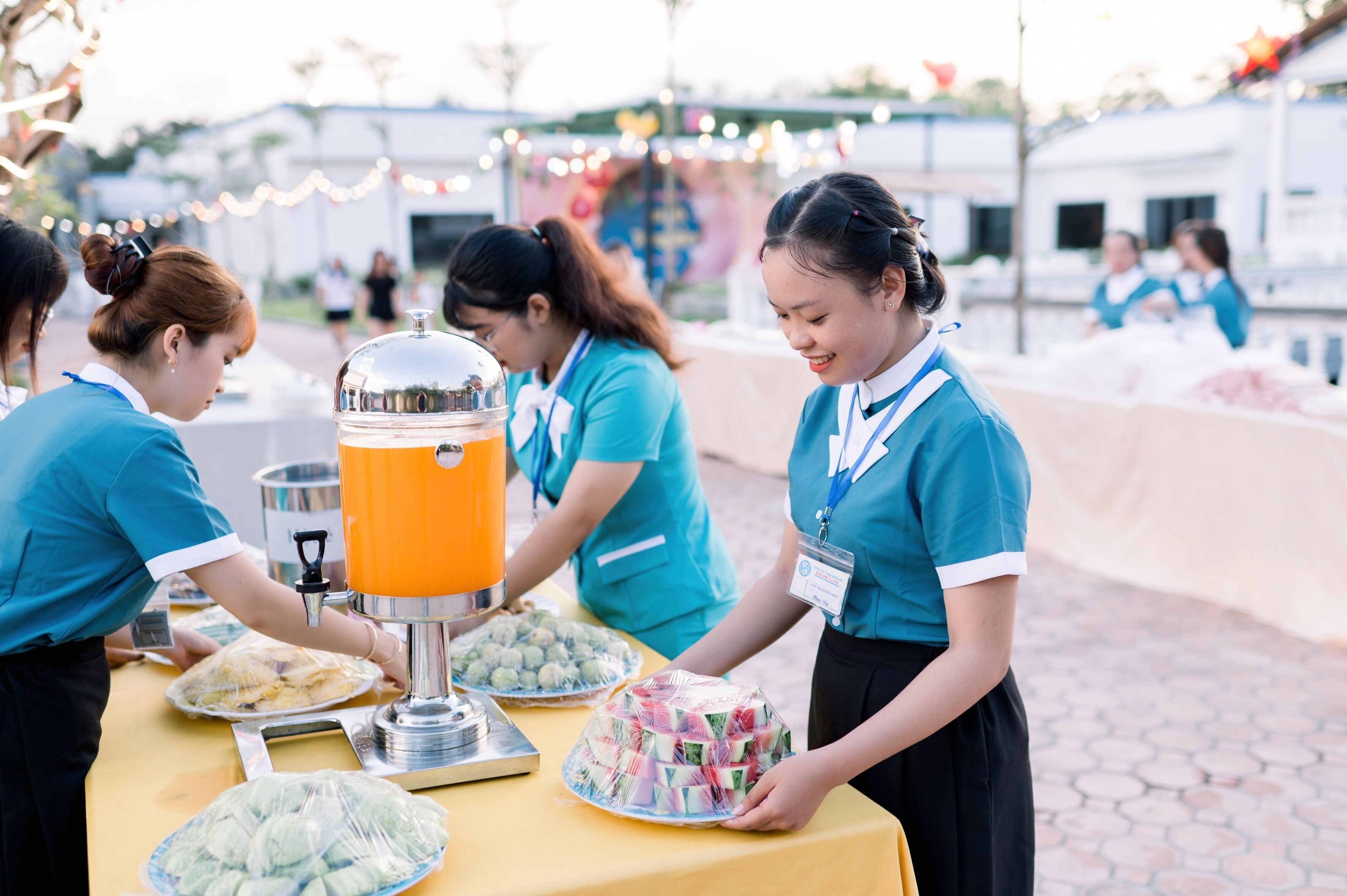 A buffet setup with food items and a beverage dispenser.