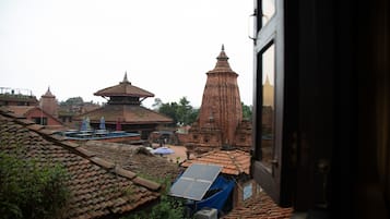 A traditional building with a large central tower and smaller structures around it.