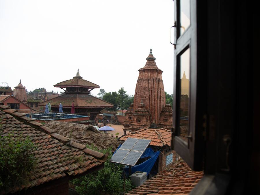 A traditional building with a large central tower and smaller structures around it.
