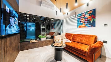Design Mobile Home, Patio, Garden View | Living area | 55-inch Smart TV with cable channels, first-run films, heated floors