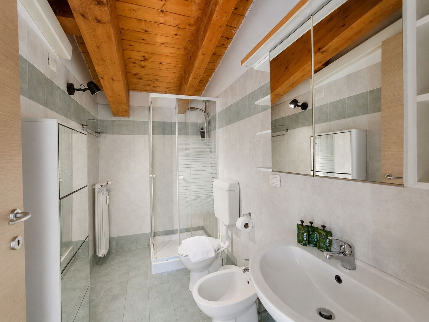 Ein modernes Badezimmer mit Dusche, Toilette, Bidet und einem großen Waschbecken.