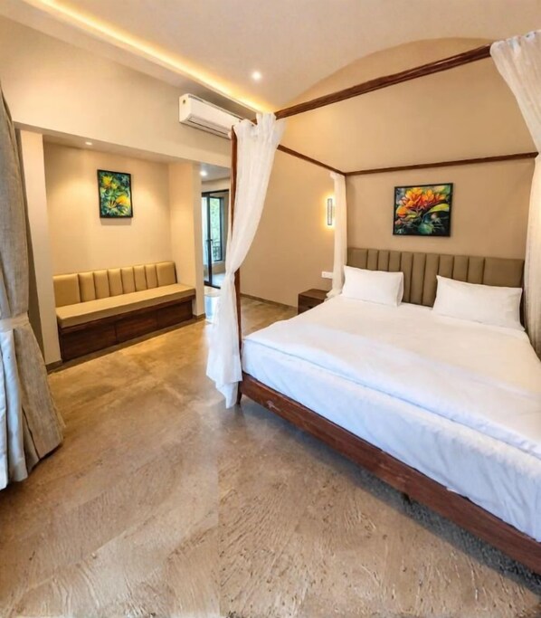 A bedroom with a four-poster bed, a bench, and two paintings on the walls. - Jomo Resort (Alibag)