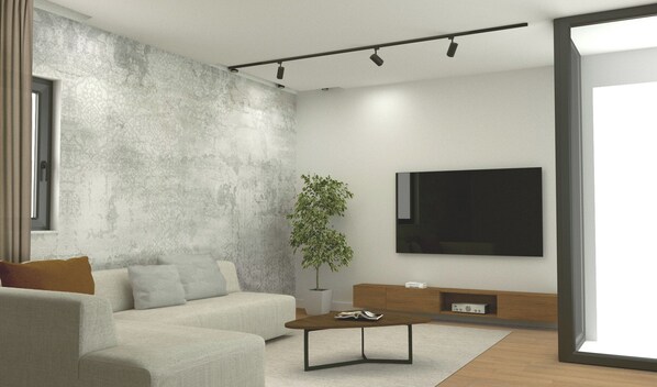 A modern living room with a grey textured wall, a sofa, a coffee table, a plant, and a flat-screen TV mounted on the wall. - Porta Bibinje Villas & Residence (Bibinje)