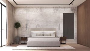 Ein modernes Schlafzimmer mit einem großen Bett, zwei Nachttischen, einer Topfpflanze und einem großen Fenster.