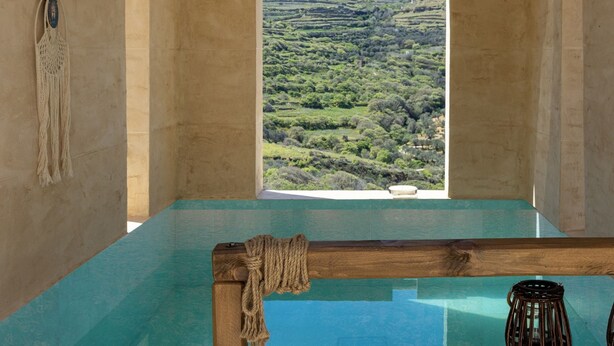 A room with a large window overlooking a hilly landscape. - The Hydor Element Of Gaea (Tinos)