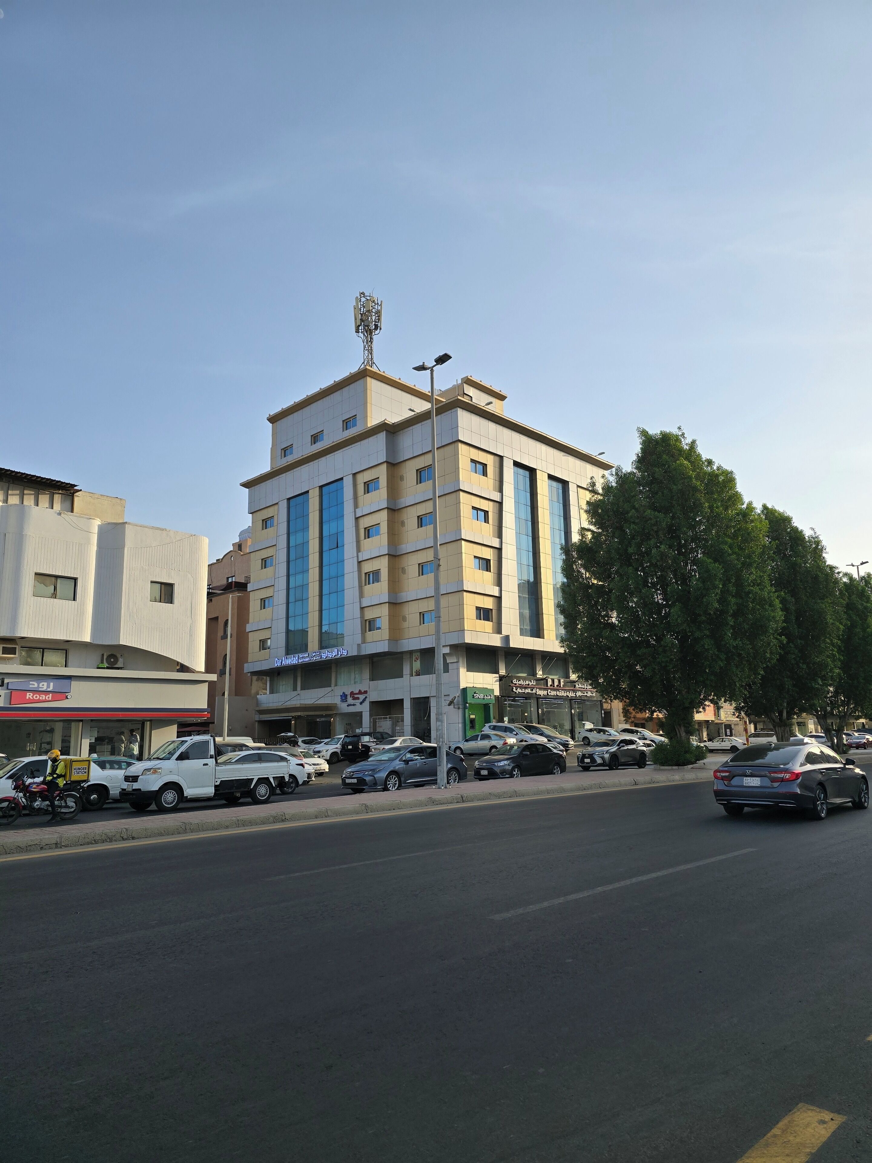 A multi-story building with a modern design, featuring a mix of commercial and residential spaces.