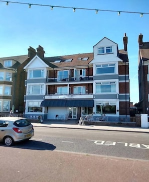 A multi-story building with a ground-level restaurant and upper residential units. - Three Bedroom - Apartment (Skegness)