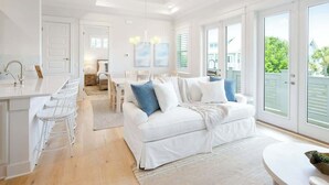 Un luminoso espacio tipo loft con cocina, comedor y un amplio ventanal corredera al exterior.