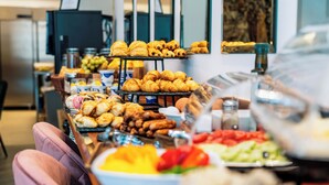A buffet table with various food items including pastries, fruits, and vegetables. - Yolanda Boutique Hotel  (Birgu)
