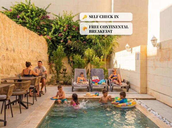 Piscine extérieure, parasols de plage, chaises longues