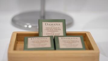 A wooden box containing three bars of Damana gentle soap.