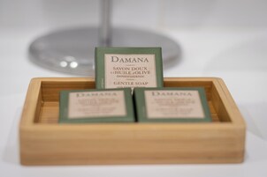 A wooden box containing three bars of Damana gentle soap.