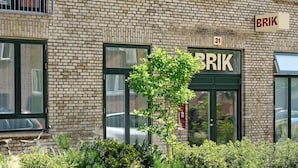 A brick building with a sign reading "BRIK" and the number "31" above the entrance.
