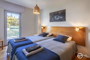 A hotel room with two beds, a large window, and a balcony. - Home Azores - Pico do Salomão Poolside Retreat (Ponta Delgada)