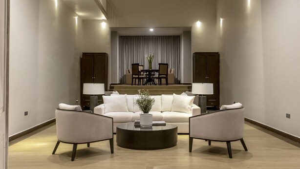A spacious living room with a sofa, two armchairs, and a coffee table. There is a dining area in the background with a table and chairs. - W15 Glenfall Nuwara Eliya (Nuwara Eliya)