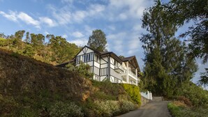 A two-story house with a balcony, surrounded by lush greenery and trees. - W15 Glenfall Nuwara Eliya (Nuwara Eliya)