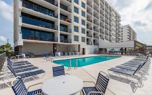 A hotel with a large pool area, multiple balconies, and outdoor seating. - Island Winds West 774 : Gulf Views | Beachfront Condo w/ Pools, Walk to Hangout (Gulf Shores)