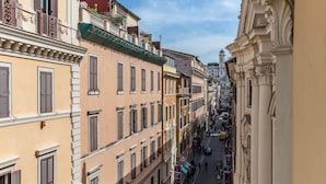 A narrow street lined with historic buildings, featuring balconies and traditional architecture. - Palazzo Goldoni Condotti Collection (Rome)
