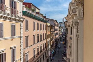 A narrow street lined with historic buildings, featuring balconies and traditional architecture. - Palazzo Goldoni Condotti Collection (Rome)