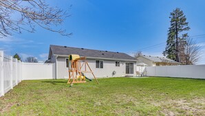 A house with a backyard, a swing set, and a tall tree. - Charming Home w/ Patio: 3 Mi to Hayden Lake! (Hayden)