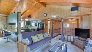 A wooden interior with a sofa, coffee table, and a television. - Cozy Cabin in Pine Mountain Lake Near Yosemite! (Groveland)