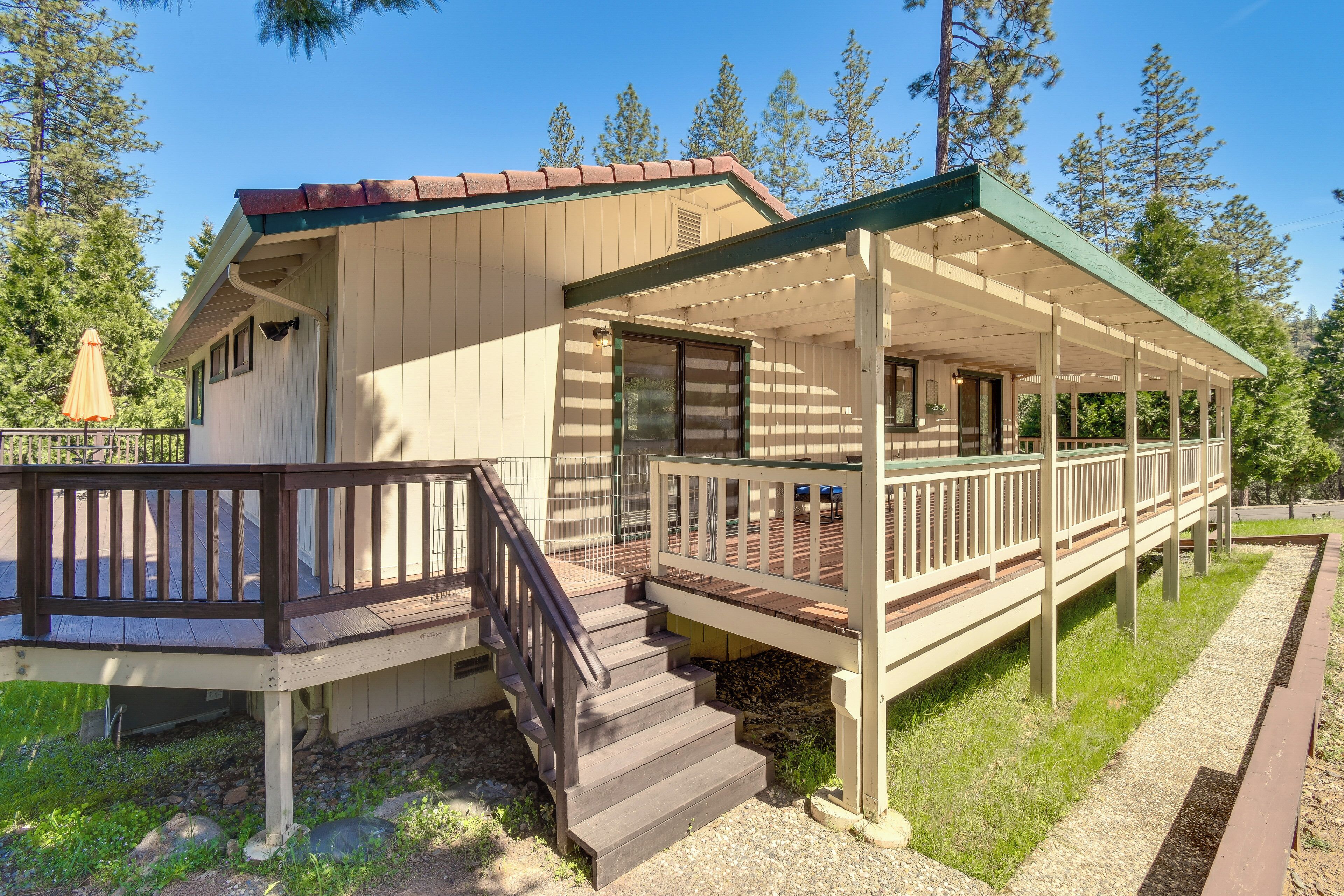 A two-story building with a covered porch and a staircase leading to the upper level.